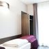 Fair Hotel Europaallee Frankfurt am Main guest room with single bed, desk, TV and floor-to-ceiling window