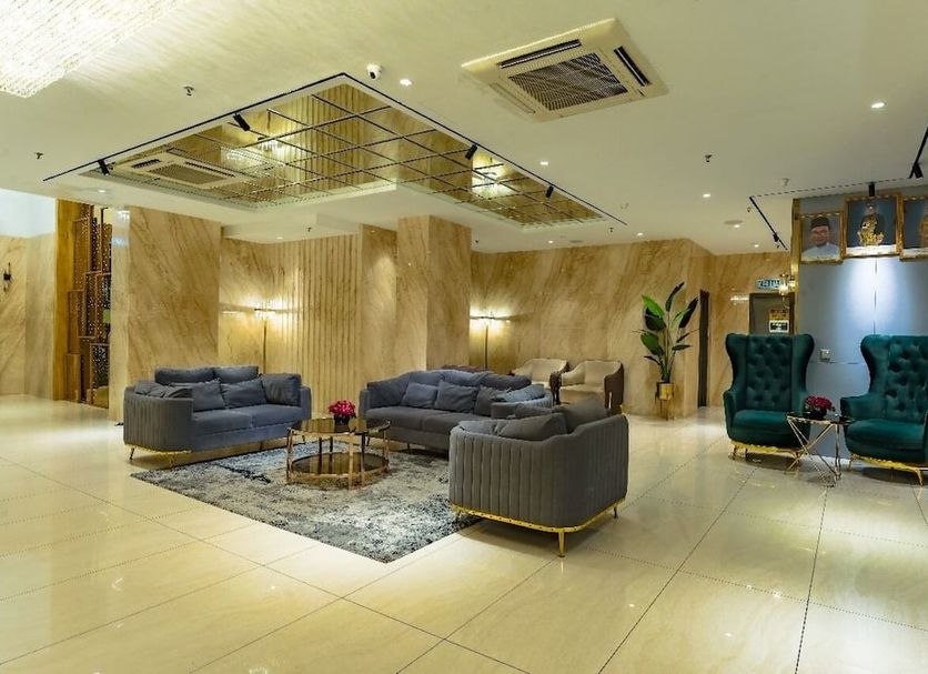 Lazdana Hotel Kuala Lumpur lobby lounge with gray sofas, velvet chairs and modern ceiling lights