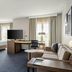 Residence Inn by Marriott Chicago Naperville/Warrenville suite with king bed, desk, sofa and TV in Warrenville