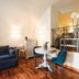 Teichnersuite Rome suite with loft bed, sitting area, and wood floors