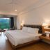 Country Inn Premier Pacific Mall Road Mussoorie room with king bed and large window mountain view