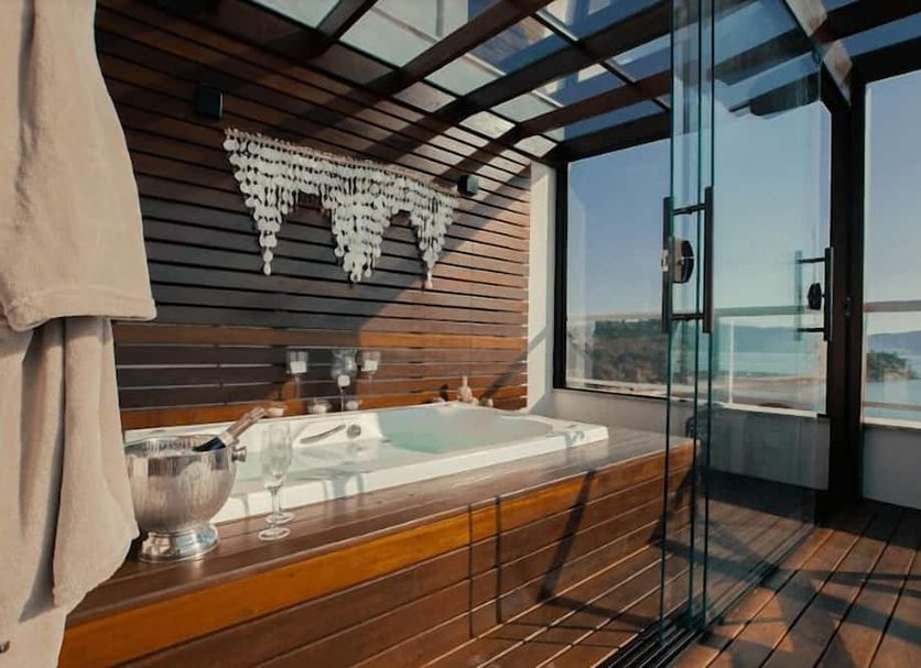 Hotel Villareal São Francisco do Sul spa tub with ocean view and glass wall balcony