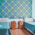 Art Factory San Telmo in Buenos Aires twin room with colorful mural and bedside tables