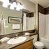 Sooke Harbour Resort & Marina bathroom with vanity, mirror, toilet, and shower-tub combo in Sooke.