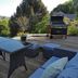 Bryn Melyn Apartments in Barmouth terrace with seating, barbecue and coastal hillside view