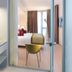 The Passage - Urban & Lifestyle Hotel Basel room view with vanity sink and bedroom through glass doors
