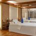 F1 Hotel Manila in Taguig spa treatment room with two massage beds and stone accent wall