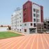 Sai Sangam Hotel in Shirdi, exterior with lawn and multi-story building
