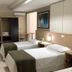 Hotel Steinhausen, Blumenau: twin beds in a simple hotel room with TV, desk and wardrobe