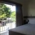 Resort L'acqua Diroma V room with bed and balcony overlooking trees in Caldas Novas