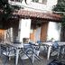 Outdoor courtyard at Albergue Rural Cal Picarol in Àger with tables and chairs under a stone overhang