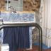 Bathroom at Albergue Rural Cal Picarol in Àger with tiled sink, mirror lights and shower curtain