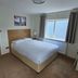 Homefield Lodge in London guest room with double bed, window, bedside lamp and tea tray