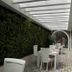 Casa Hotel Boyaca Real in Bogotá with covered outdoor dining terrace and green wall