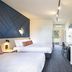 Nightcap at Sandown Park Hotel, Noble Park: modern twin hotel room with desk, wall art and natural light