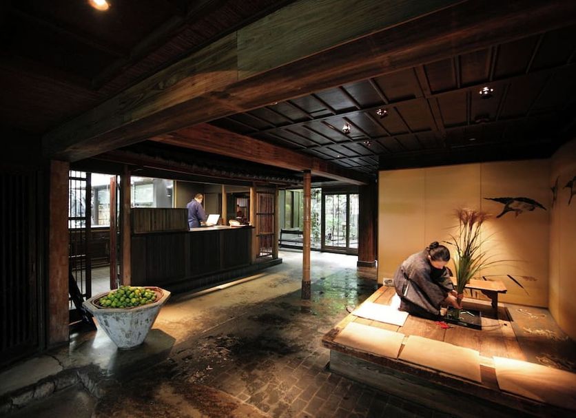 Yuzuya Ryokan Kyoto interior with a reception desk, seating area, and traditional Japanese decor