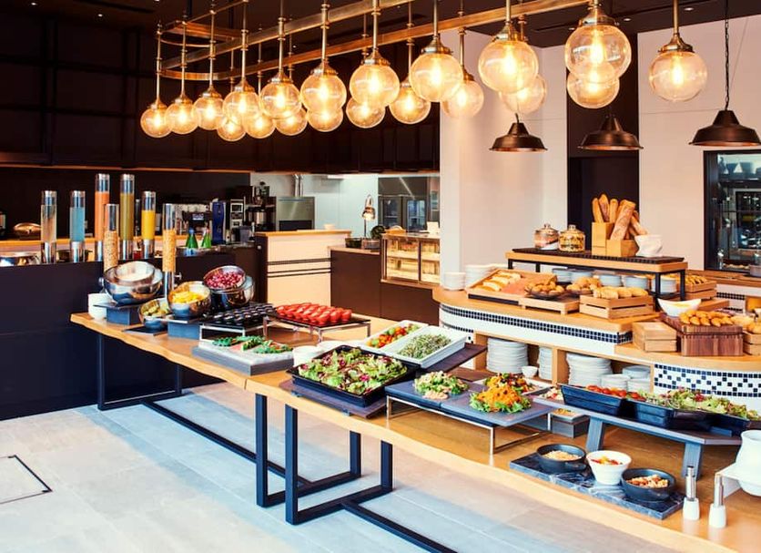 Liber Hotel Osaka in Osaka breakfast buffet with salads, pastries and hanging pendant lights
