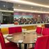 Puteri Bay Hotel, Malacca: bright dining area with round tables and red chairs