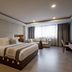 Origen 438 Luxury Boutique Hotel in Guadalajara guest room with king bed, sofa seating, and large window