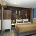 The Muse Amsterdam Boutique Hotel room with double bed, mural wall art, wardrobe, and window in Amsterdam