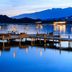 Grand Hôtel De Cala Rossa, Porto-Vecchio: tranquil waterfront pier with boats and mountain views at dusk