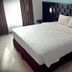 Grand Orchid Hotel Yogyakarta in Depok: guest room with king bed, padded headboard and curtains