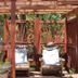Historic Smith Hotel B&B in Glendale: shaded wooden pergola with lounge chairs and garden accents