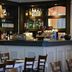 Tongadale Hotel in Portree bar area with shelves of bottles and tables in front