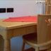 Borcanela Apartments in Moena room with wooden desk, chair and red table runner