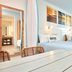 Universal Endless Summer Resort Dockside guest room in Orlando with two beds and bright window curtains