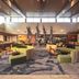 Universal Endless Summer Resort Dockside lobby lounge in Orlando with curved green seating and tall tree sculptures