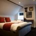The Stag Rooms, Alcester: cozy attic-style bedroom with double bed, skylights, and wall mirror