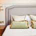 Dog and Partridge by Greene King Inns bedroom with upholstered headboard and bedside lamp in Bury St. Edmunds