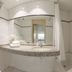 Arass Hotel & Business Flats Antwerp bathroom with curved vanity, mirror, shower and bathtub