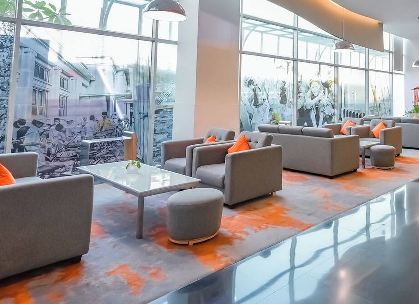 Harris Hotel & Convention Festival Citylink Bandung lobby seating area with large windows and city views