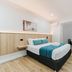 Country 2 Coast Motor Inn Coffs Harbour room with queen bed, desk, and small dining table