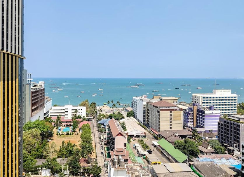 Many Holiday The Base Condo Pattaya with city and ocean view from a high-rise balcony