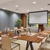 NH Madrid Nacional meeting room in Madrid with U-shaped tables, projector screen and large windows