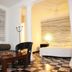 Hotel Maya del Mar in Playa del Carmen room with striped sofa, bed, table and black-and-white tile floor