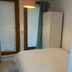 Self Contained Rooms in Central Torquay guest room with bed, wardrobe and window blinds in Torquay