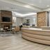 Residence Inn by Marriott Chicago Naperville/Warrenville lobby with curved front desk and fireplace seating