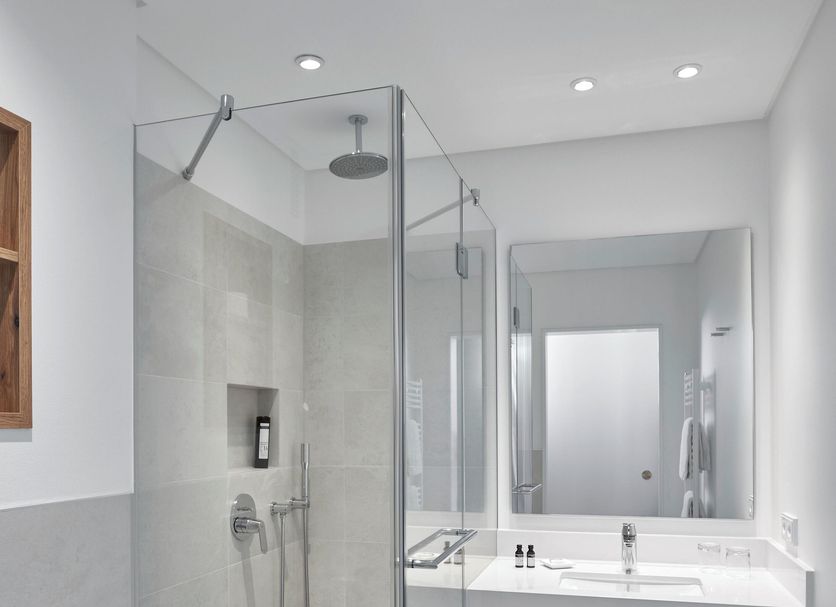 Sporthotel Grafenwald Daun bathroom with glass walk-in shower and vanity sink