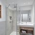 Sporthotel Grafenwald Daun bathroom with glass walk-in shower and vanity sink