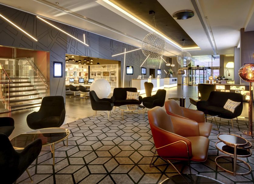 Pullman London St Pancras lobby lounge with modern seating and geometric patterned floor in London
