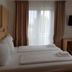 Hotel Ackermann in Riedstadt guest room with twin beds, window curtains and a small desk