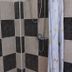 La Isla Bonita Resort in Boracay bathroom with black-and-beige tiled shower and handheld showerhead