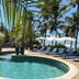 Pousada Morro dos Navegantes in Ilhéus with a tropical pool, palm trees, lounge chairs, and umbrellas