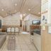 Ashmore Palms Holiday Village lobby lounge with sofa, dining table, kitchen area and TV in Ashmore