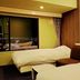 Asahikawa Park Hotel guest room with two beds and a city view in Asahikawa