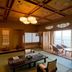 Hotel Biwanso in Nanao, traditional tatami room with ocean-view seating area and large windows